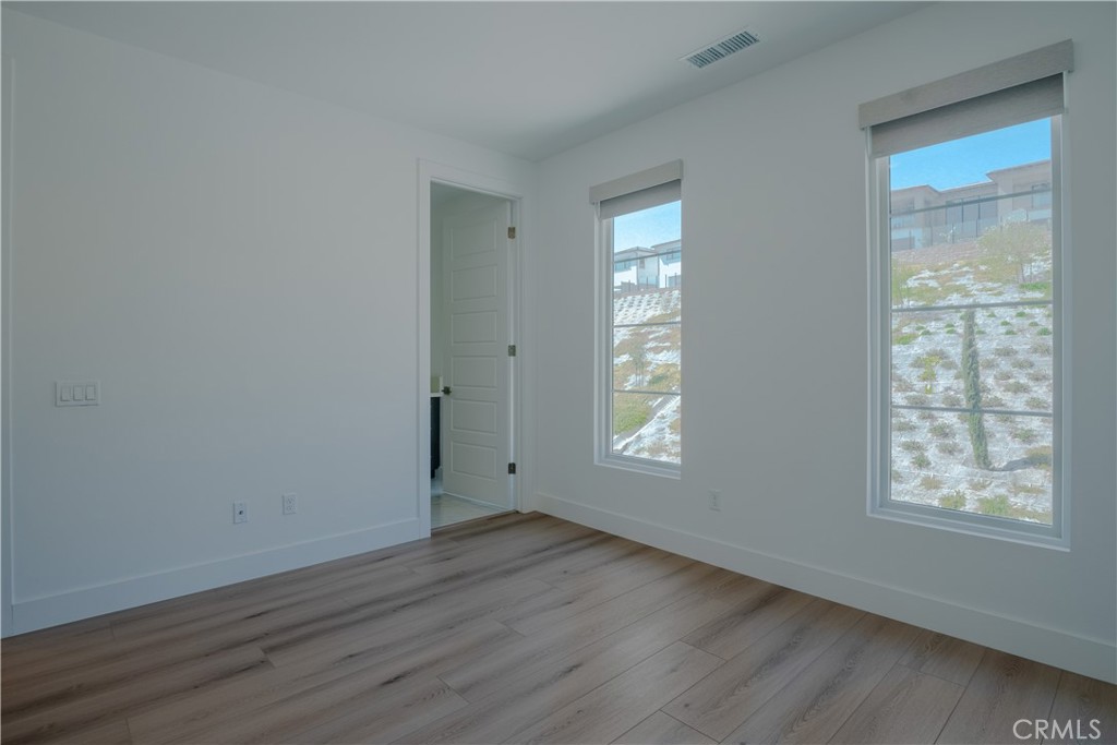 11752 Hillsborough Lane Porter Ranch, CA 91326 - Photo 38 of 45 a view of an empty room with wooden floor and a window