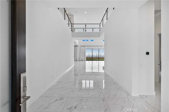 a large kitchen with a large counter top stainless steel appliances and cabinets
