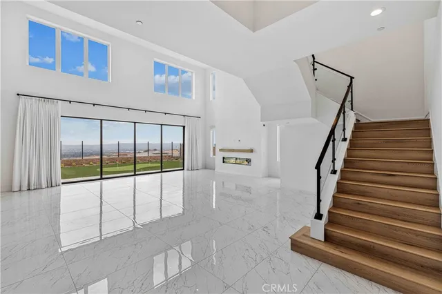 a kitchen with stainless steel appliances kitchen island granite countertop a refrigerator a sink a stove with wooden cabinets