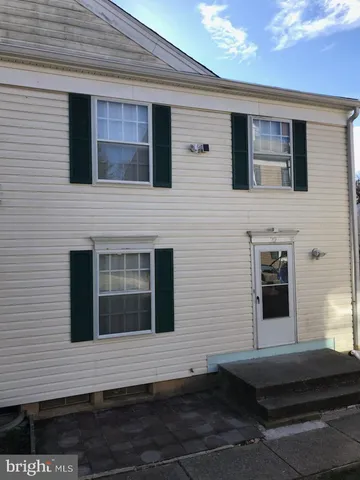 a view of a house with car parked