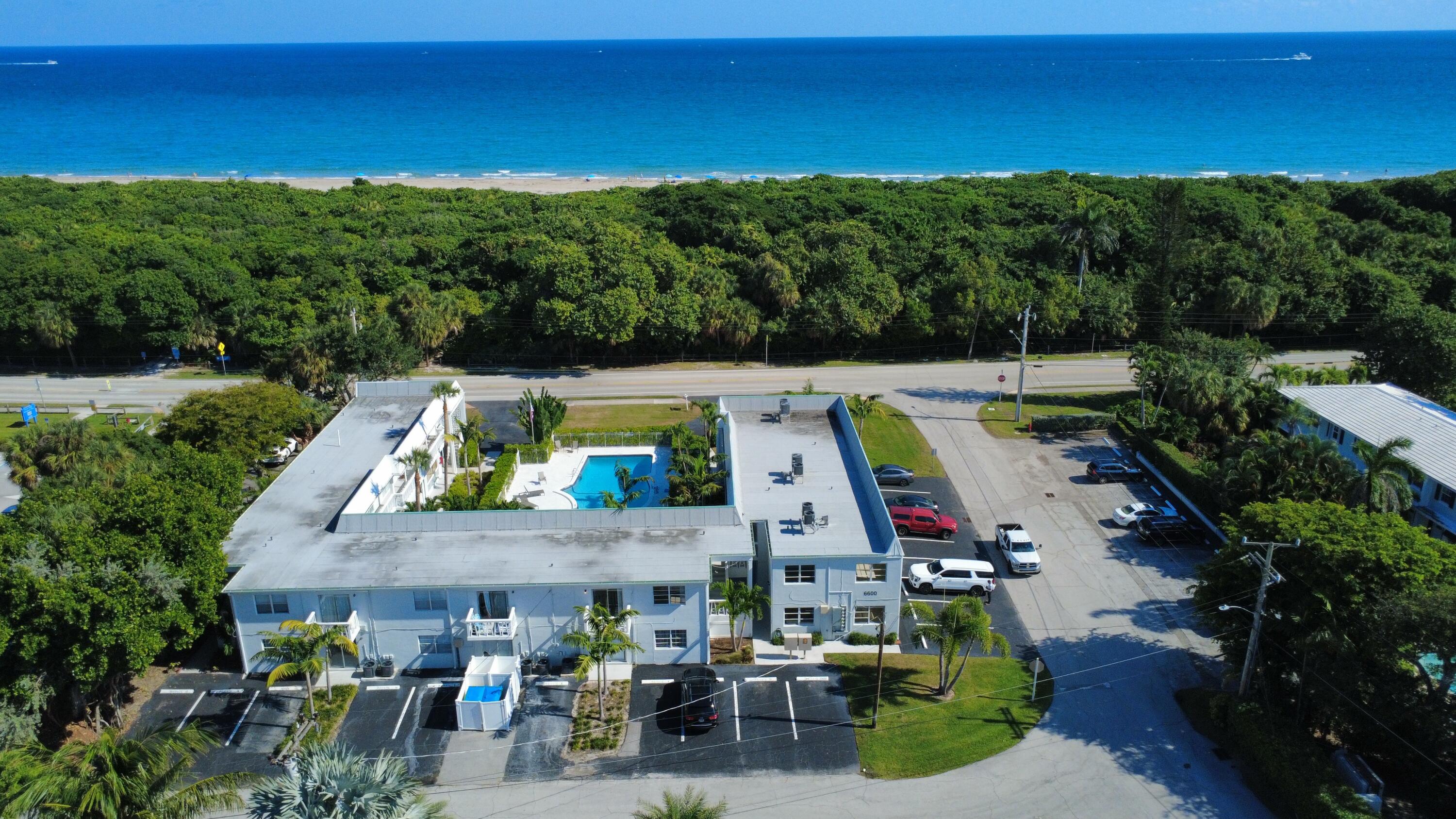 6600 North Ocean Boulevard, Unit 17 Ocean Ridge, FL 33435 - Photo 2 of 21 an aerial view of a house a yard swimming pool and outdoor seating