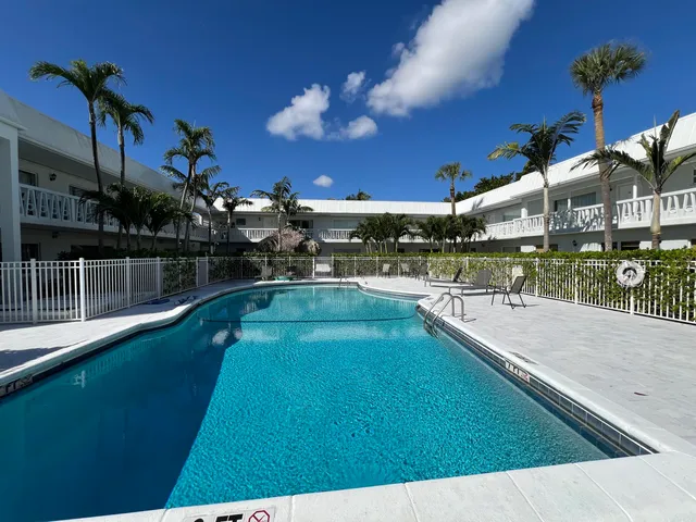 a view of a swimming pool with an outdoor seating