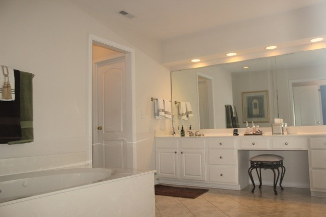 7729 Silver View Lane Raleigh, NC 27613 - Photo 14 of 25 Master bath w/ HUGE walk in closet. Garden tub. Separate shower. Double vanity. Additional large walk in closet in bathroom along with separate walk in closet. Tile flooring. Beautiful! Master Bath/Spa
