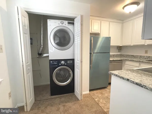 a utility room with sink dryer and washer