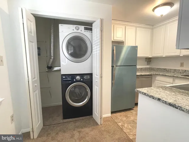 a utility room with sink dryer and washer
