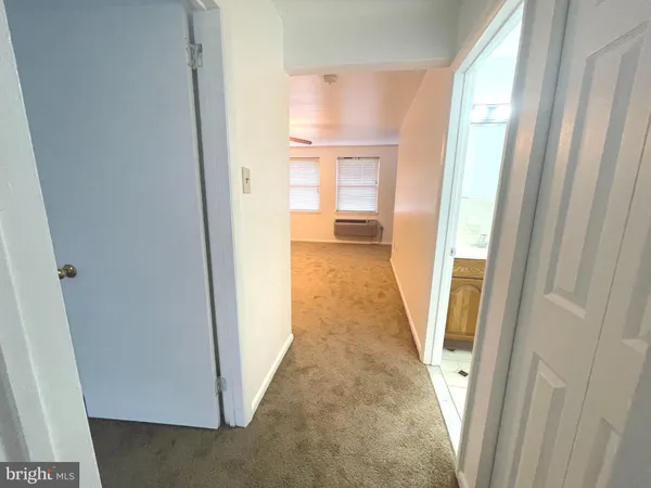 a view of a bathroom from a hallway