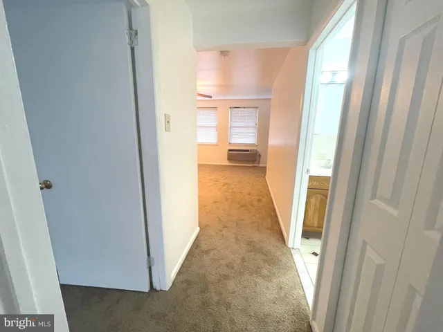 a view of a bathroom from a hallway