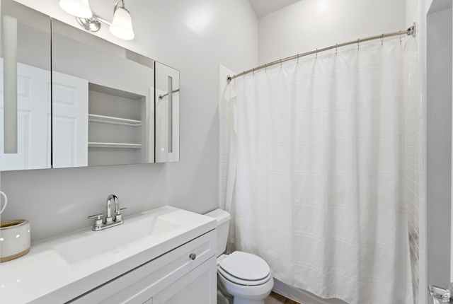 7935 Mustang Loop Road Park City, UT 84098 - Photo 38 of 60 Bathroom featuring a white vanity with integrated sink, chrome faucet, and mirrored medicine cabinet