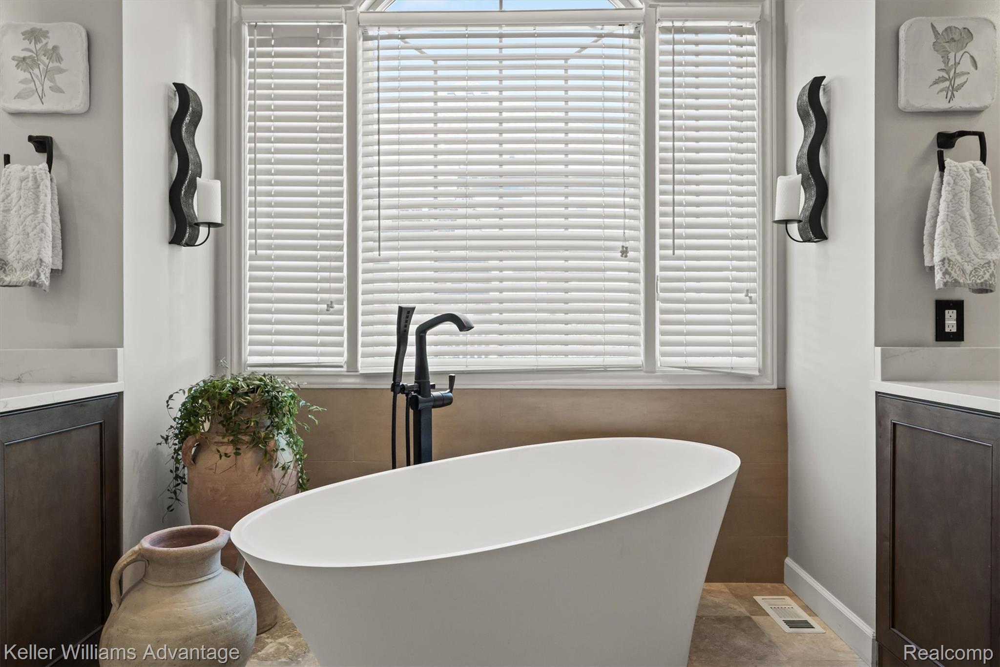 22878 Tree Top Court South Lyon, MI 48178 - Photo 21 of 75 Freestanding soaking tub with a floor-mounted matte black faucet, set against a window with blinds