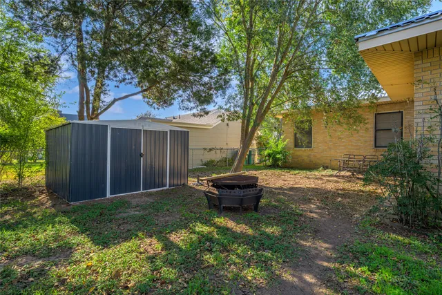a backyard of a house with yard and outdoor seating