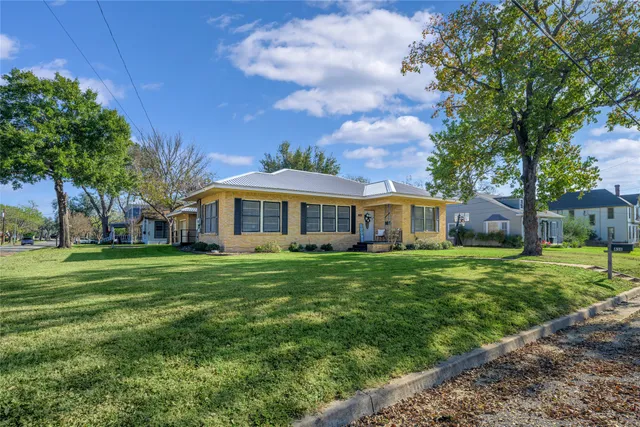 a front view of a house with a garden