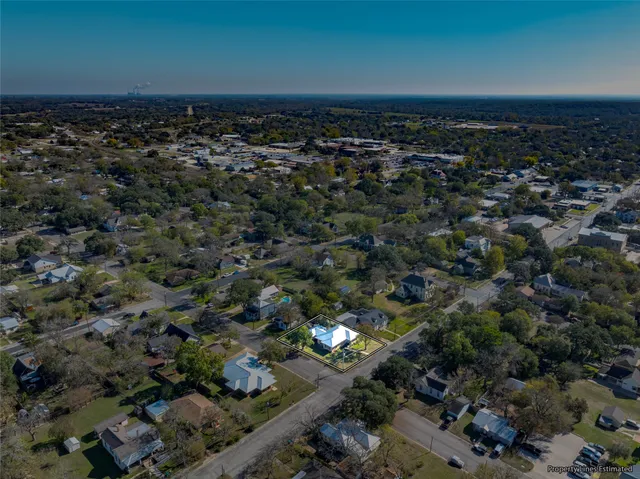 an aerial view of a residential houses with city view
