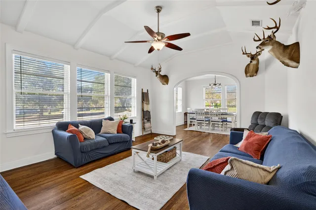 a living room with furniture ceiling fan and a window