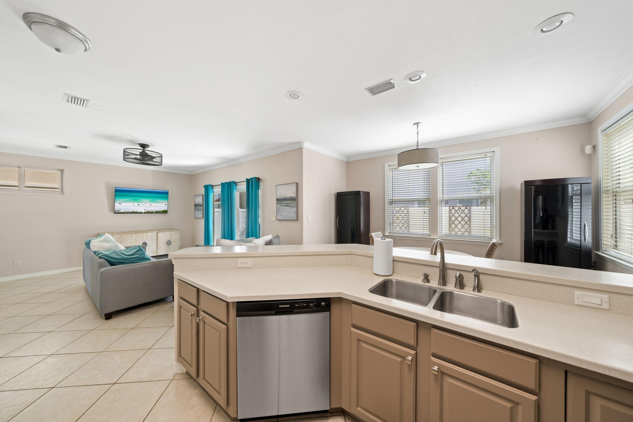 229 Inverrary Drive Destin, FL 32541 - Photo 13 of 35 a kitchen with stainless steel appliances granite countertop a sink and dishwasher with white cabinets