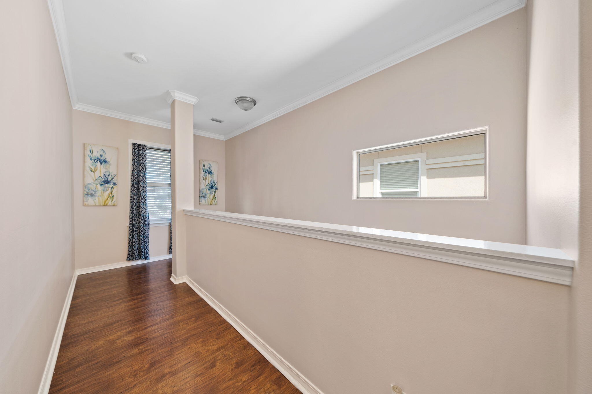 229 Inverrary Drive Destin, FL 32541 - Photo 14 of 35 a view of a hallway with wooden floor and a bathroom