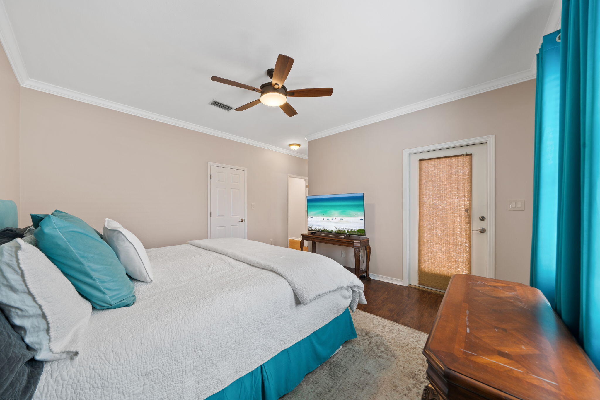 229 Inverrary Drive Destin, FL 32541 - Photo 18 of 35 a bedroom with a bed and a chandelier