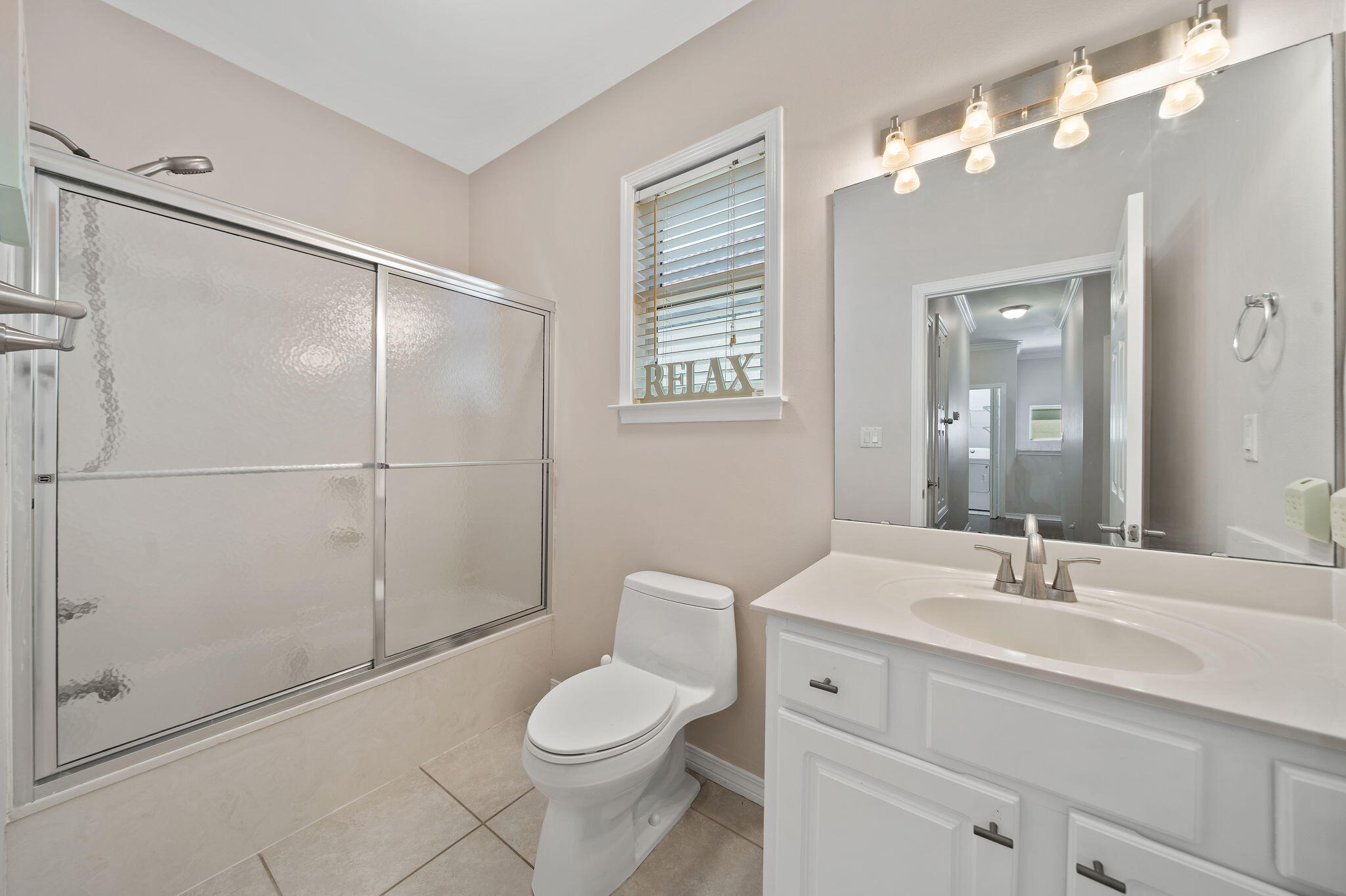 229 Inverrary Drive Destin, FL 32541 - Photo 23 of 35 a bathroom with a toilet a sink a mirror a vanity and shower