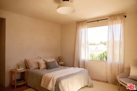 a bedroom with a bed and a window