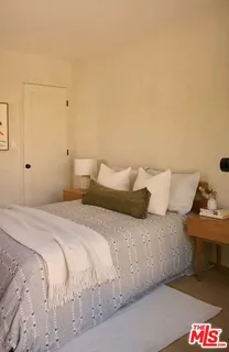 a bedroom with a bed and a couch
