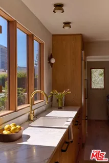a bathroom with a granite countertop sink and a window
