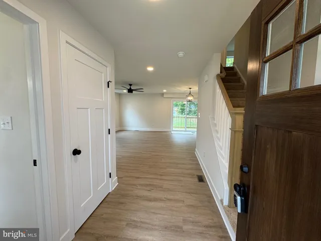 a view of hallway with wooden floor