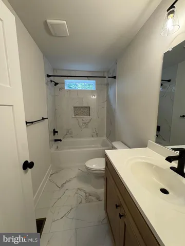 a room with pool table and windows