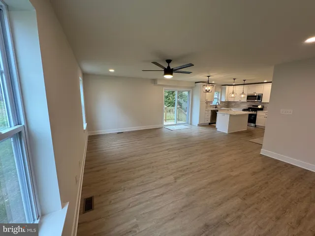 a view of a kitchen with a sink cabinets and wooden floor