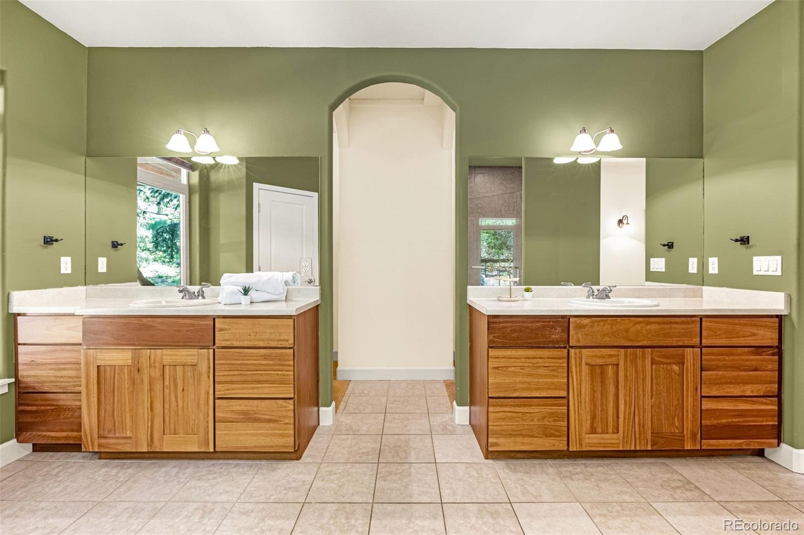 4775 Neeper Valley Road Manitou Springs, CO 80829 - Photo 16 of 41 a bathroom with a double vanity sink and a mirror