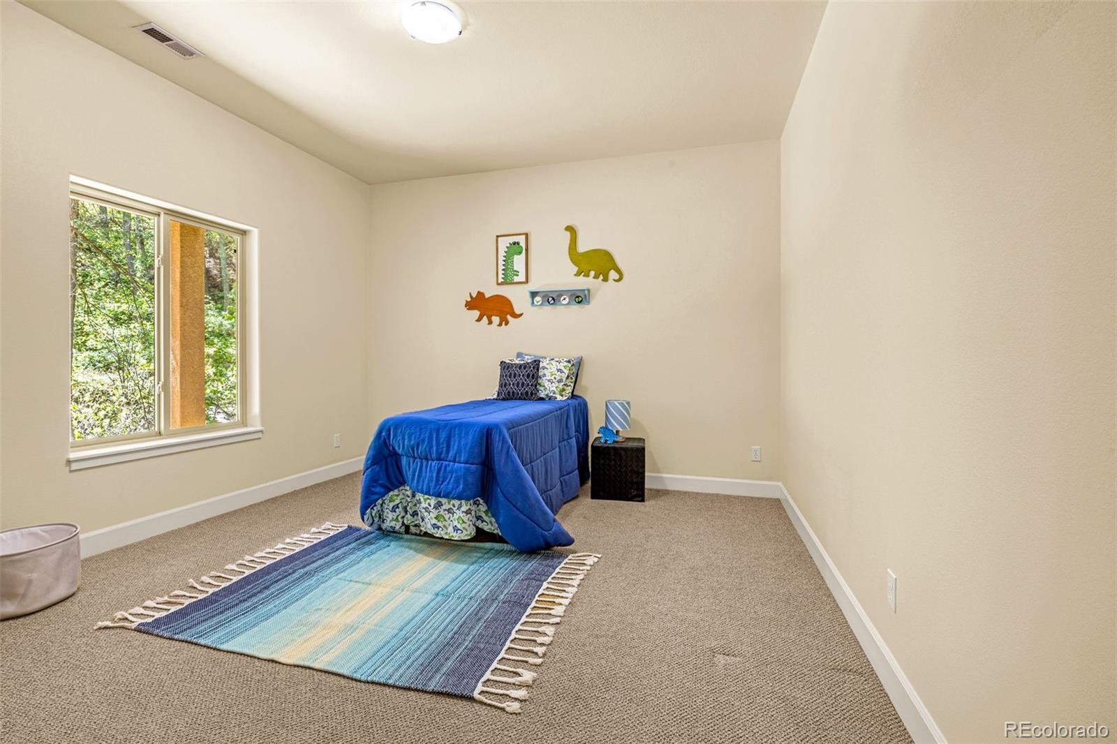 4775 Neeper Valley Road Manitou Springs, CO 80829 - Photo 25 of 41 a living room with couch and a window