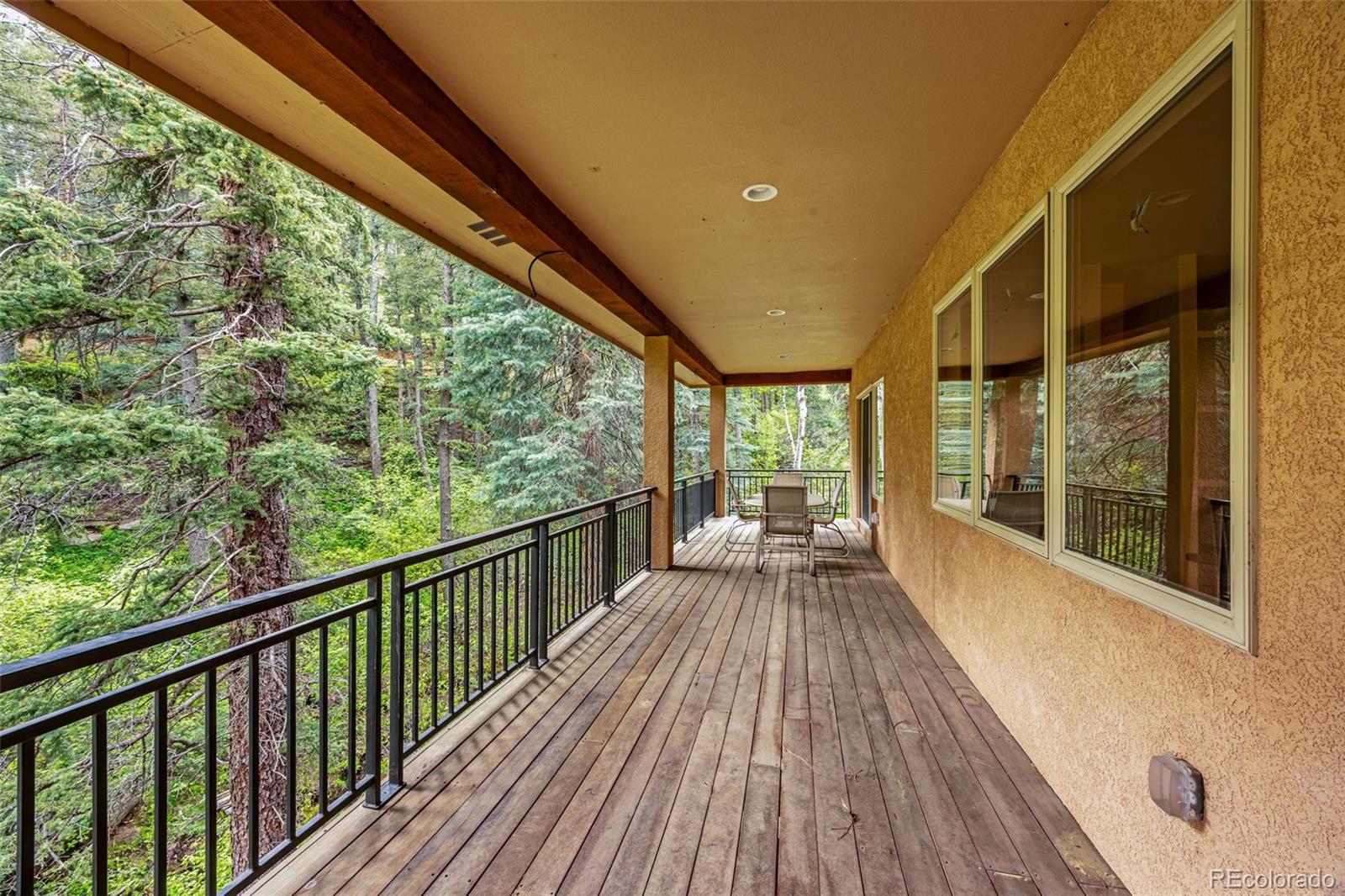 4775 Neeper Valley Road Manitou Springs, CO 80829 - Photo 31 of 41 a view of a balcony with wooden floor