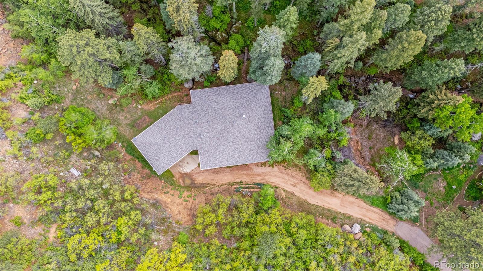 4775 Neeper Valley Road Manitou Springs, CO 80829 - Photo 35 of 41 an aerial view of a house with a yard and a large tree
