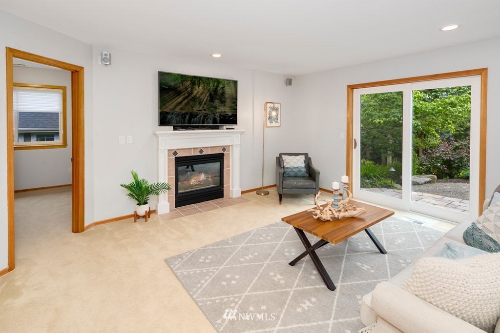 9415 Northeast 175th Street Bothell, WA 98011 - Photo 14 of 35 a living room with furniture a rug and a floor to ceiling window
