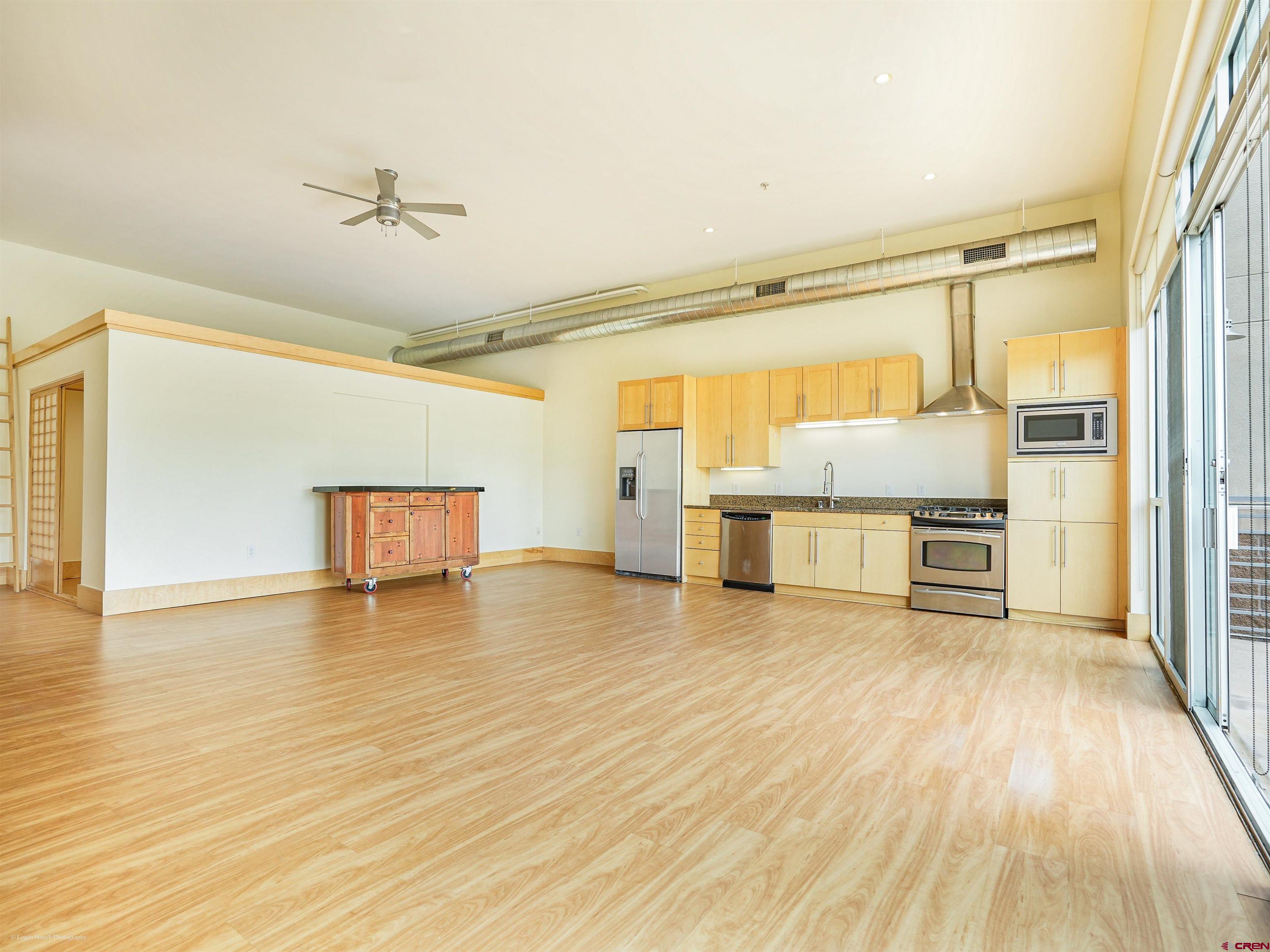 555 Rivergate Lane, Unit B2139 Durango, CO 81301 - Photo 12 of 32 a view of an empty room with wooden floor and a window