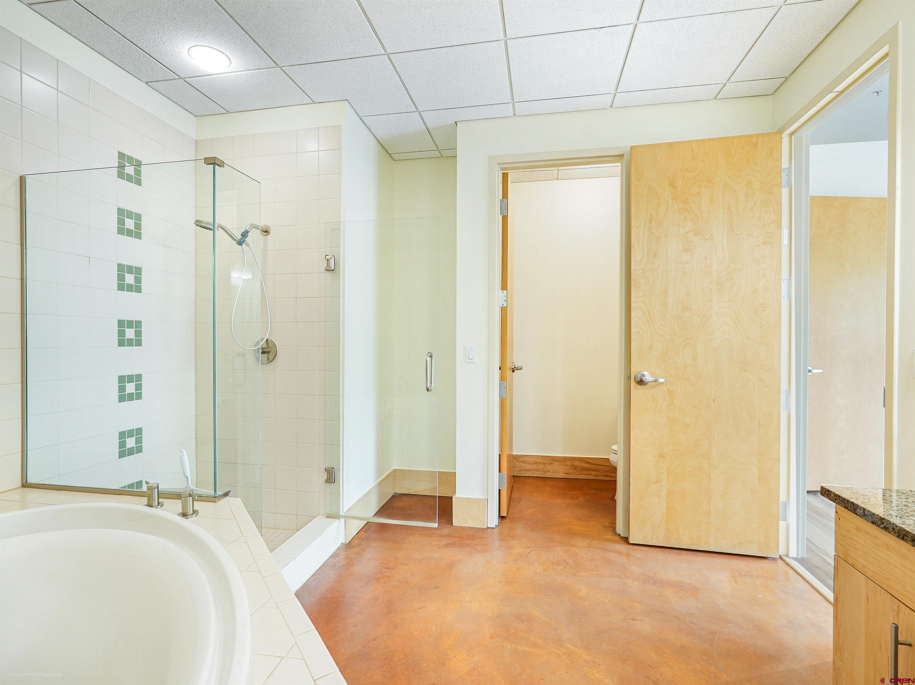555 Rivergate Lane, Unit B2139 Durango, CO 81301 - Photo 18 of 32 a spacious bathroom with a tub shower and a sink