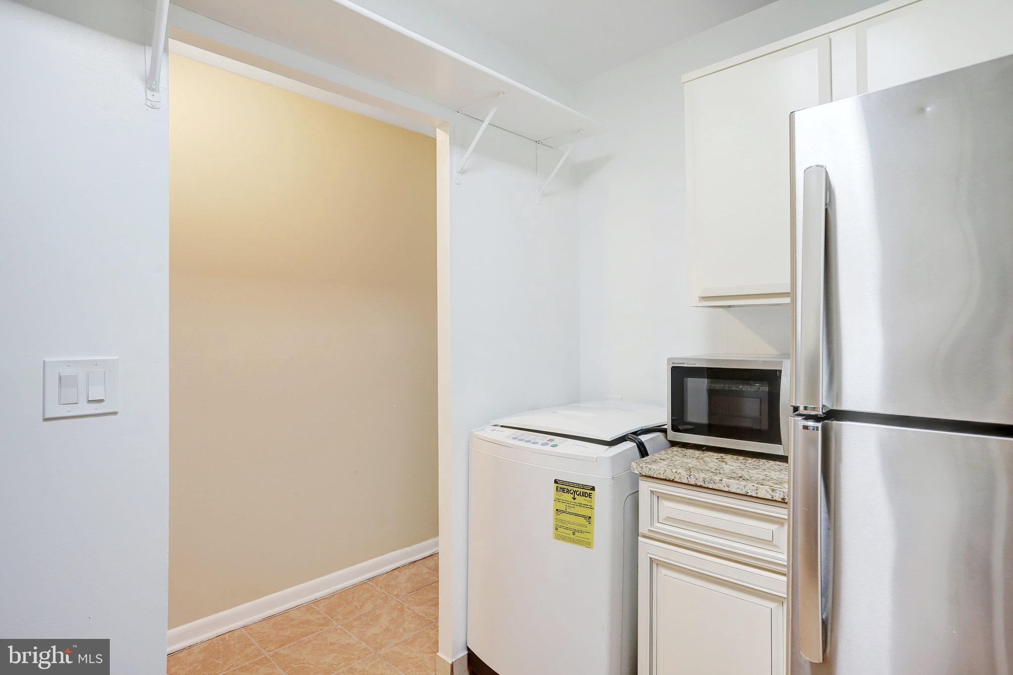 42 G Street Southwest Washington, DC 20024 - Photo 34 of 54 a view of a refrigerator in kitchen and an empty room