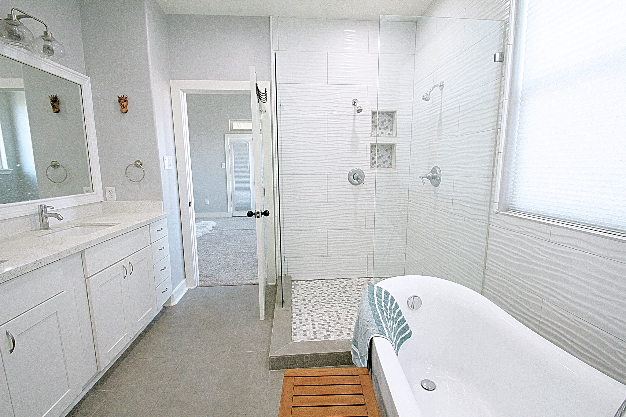 1317 Bomar Street Houston, TX 77006 - Photo 12 of 27 a bathroom with a double vanity sink a mirror a bathtub and shower