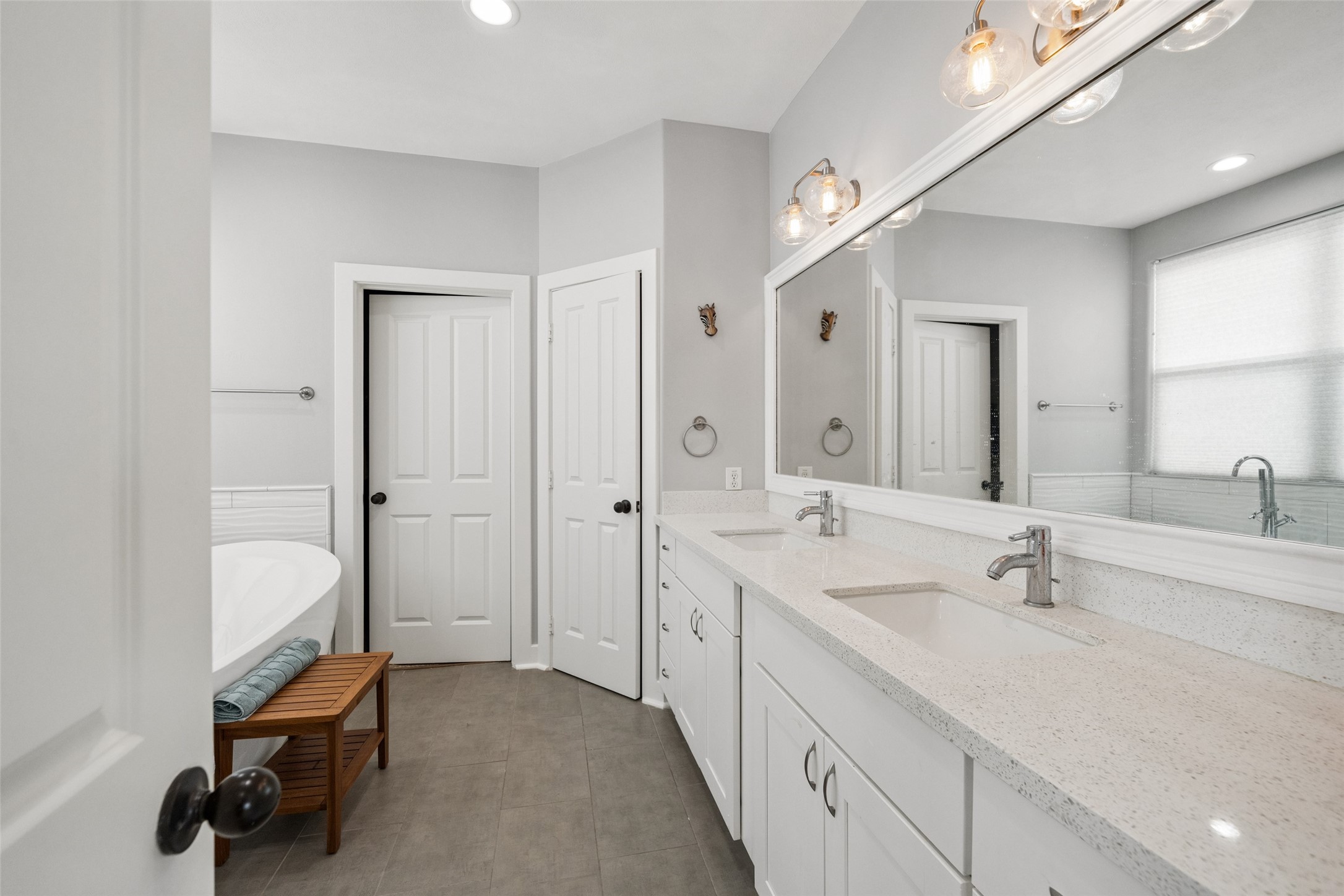 1317 Bomar Street Houston, TX 77006 - Photo 20 of 32 a spacious bathroom with a double vanity sink a mirror and a bathtub