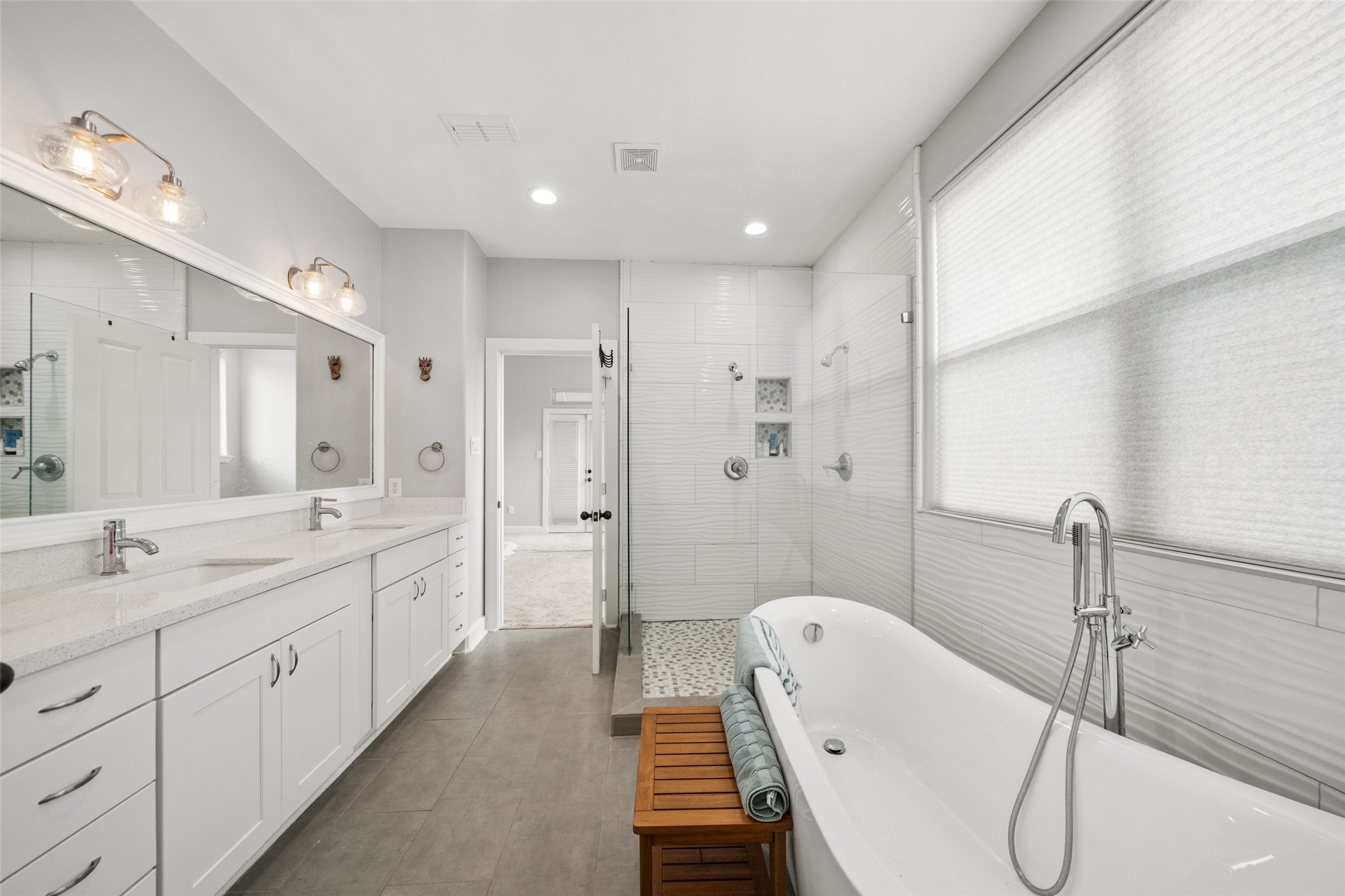 1317 Bomar Street Houston, TX 77006 - Photo 21 of 32 a spacious bathroom with a double vanity sink a mirror and a bathtub