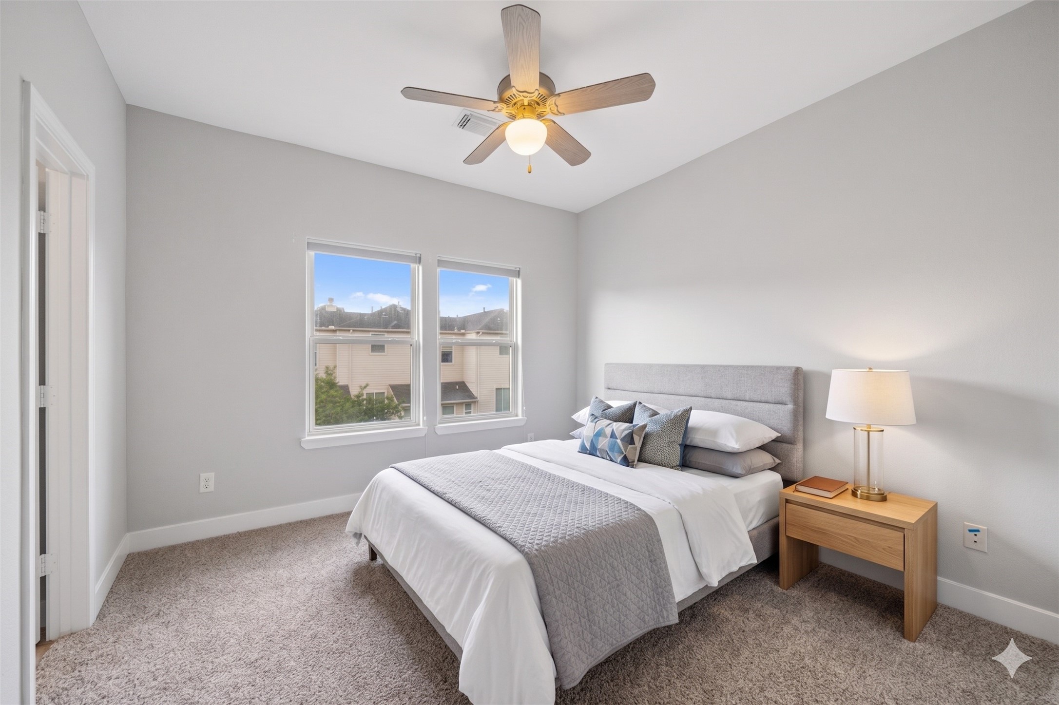 1317 Bomar Street Houston, TX 77006 - Photo 23 of 32 a bedroom with a bed and a large window