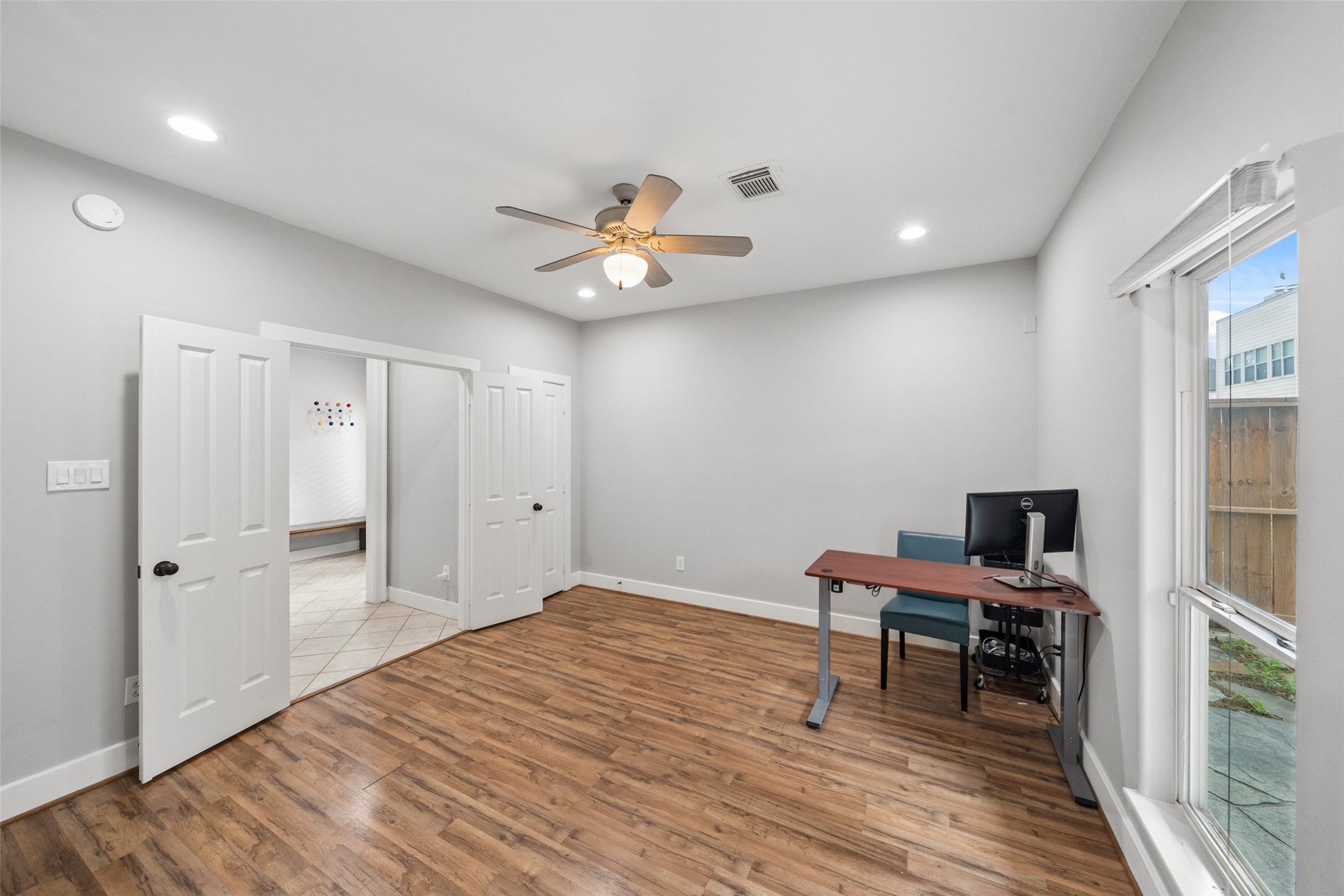 1317 Bomar Street Houston, TX 77006 - Photo 4 of 32 a view of a workspace with wooden floor and a window