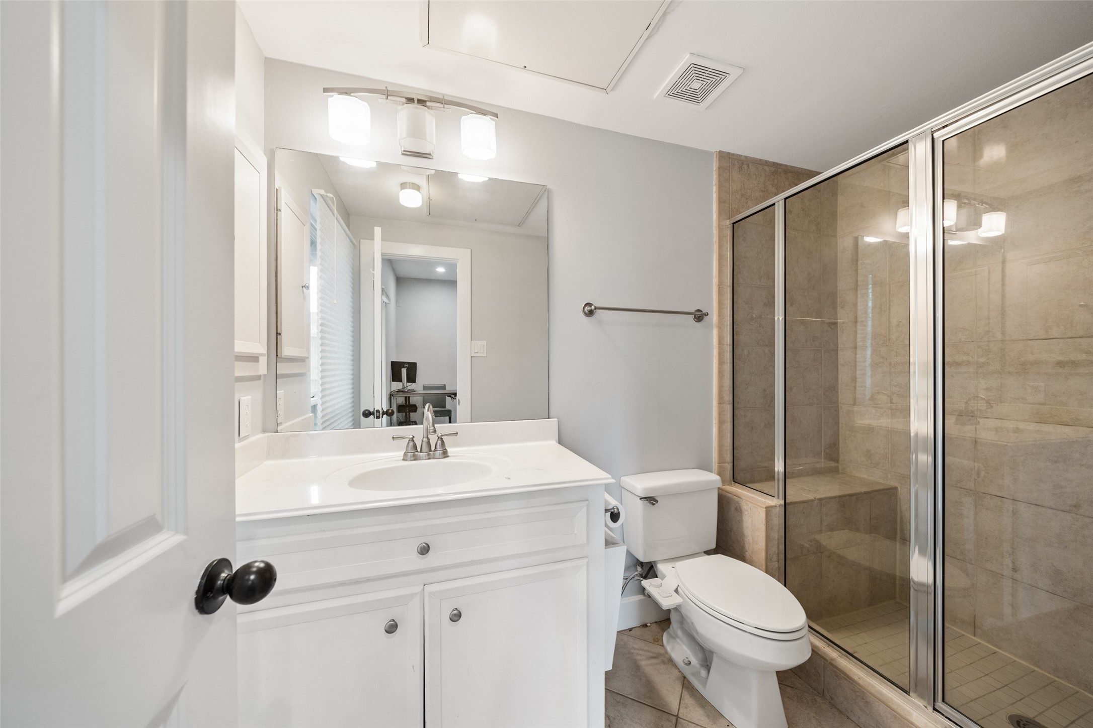 1317 Bomar Street Houston, TX 77006 - Photo 5 of 32 a bathroom with a toilet sink a mirror and shower