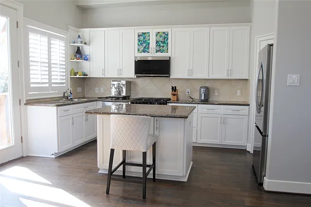 a living room with hard wood floors and a fireplace