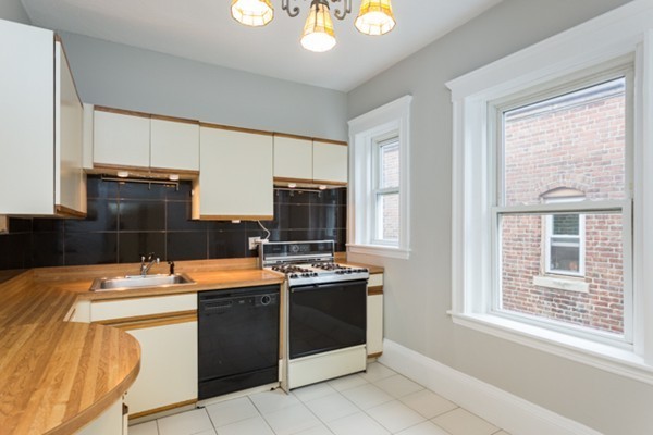 96 Naples Road, Unit 6 Brookline, MA 02446 - Photo 3 of 14 a room with a stove a sink and a refrigerator
