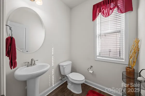 a bathroom with a sink toilet and a mirror
