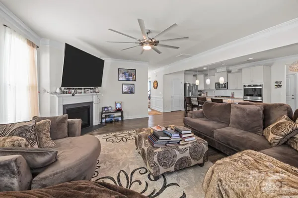 a living room with furniture a flat screen tv and a fireplace