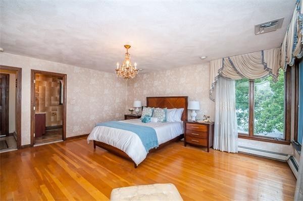 2 Lakeshore Drive Wakefield, MA 01880 - Photo 14 of 29 a bedroom with a large bed and a chandelier
