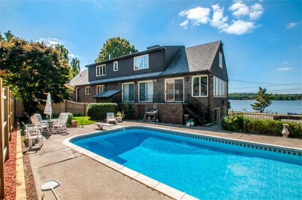2 Lakeshore Drive Wakefield, MA 01880 - Photo 20 of 29 a front view of a house with swimming pool having outdoor seating