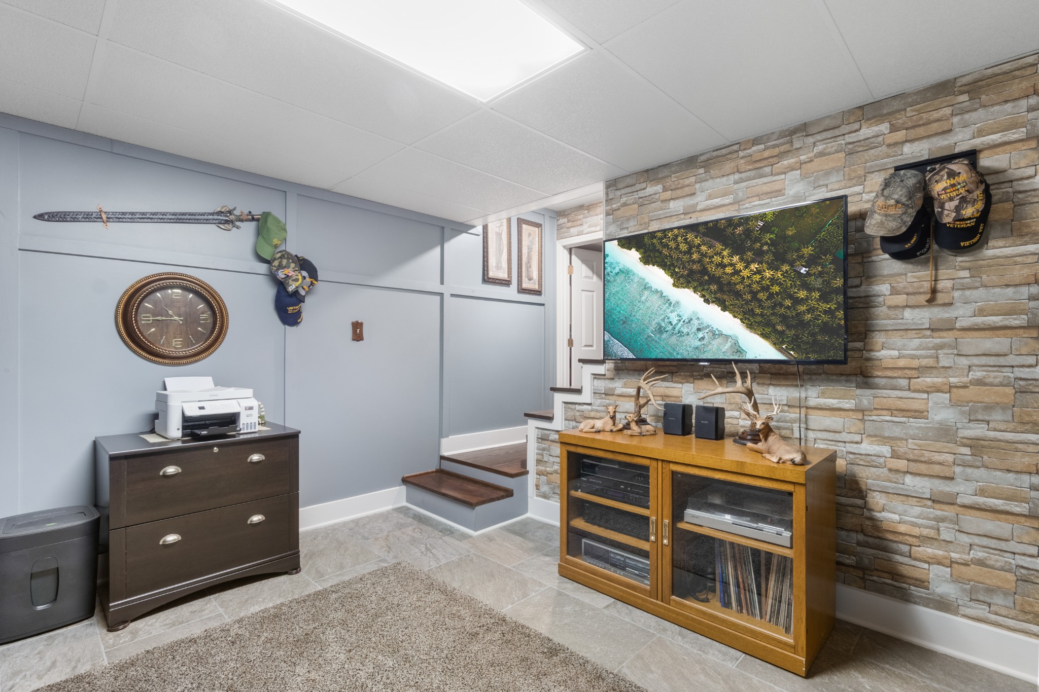 901 Riverchase Road Adams, TN 37010 - Photo 23 of 35 a room with a wooden cabinets and clock on walls