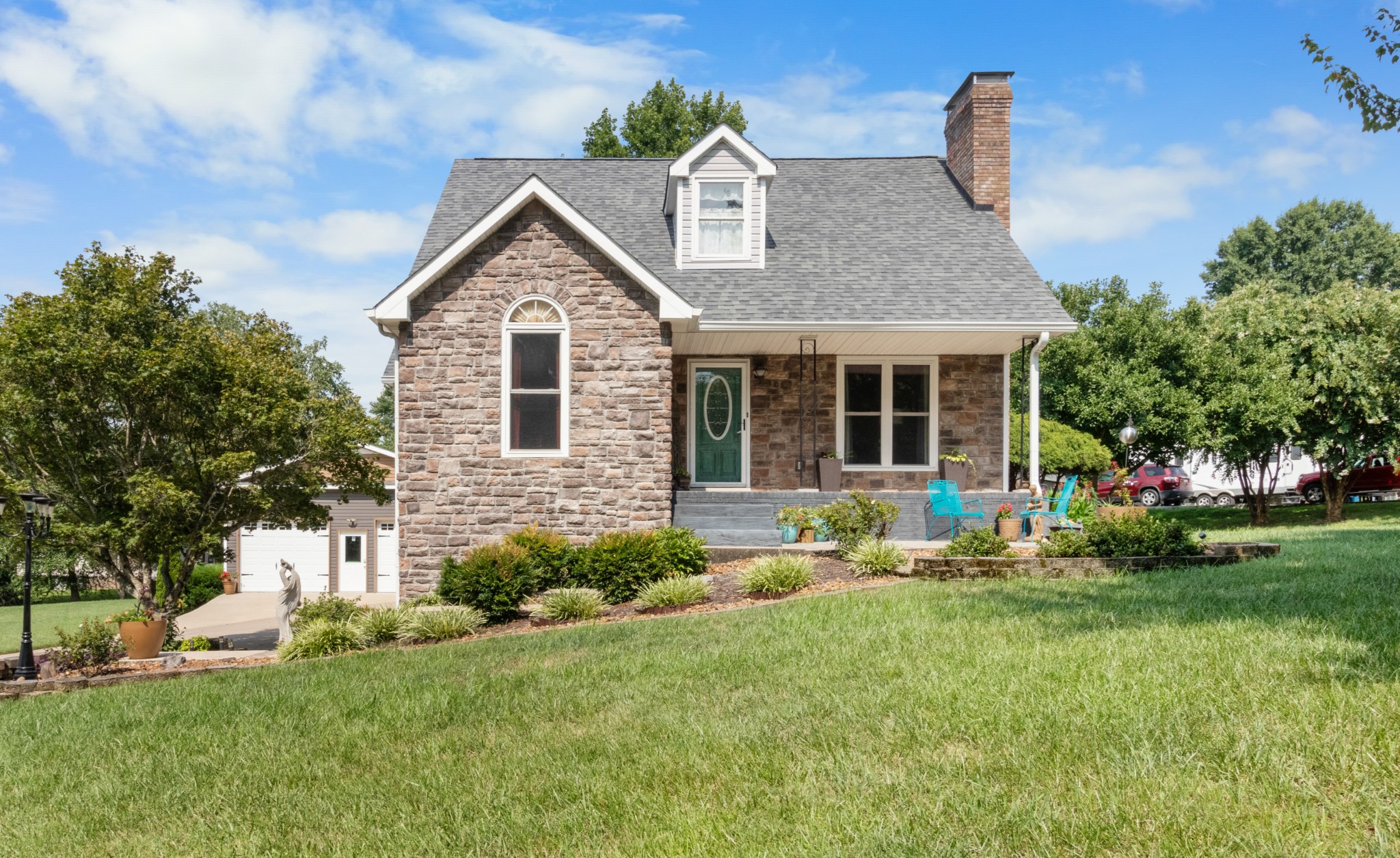 901 Riverchase Road Adams, TN 37010 - Photo 6 of 35 a front view of a house with a yard and garage