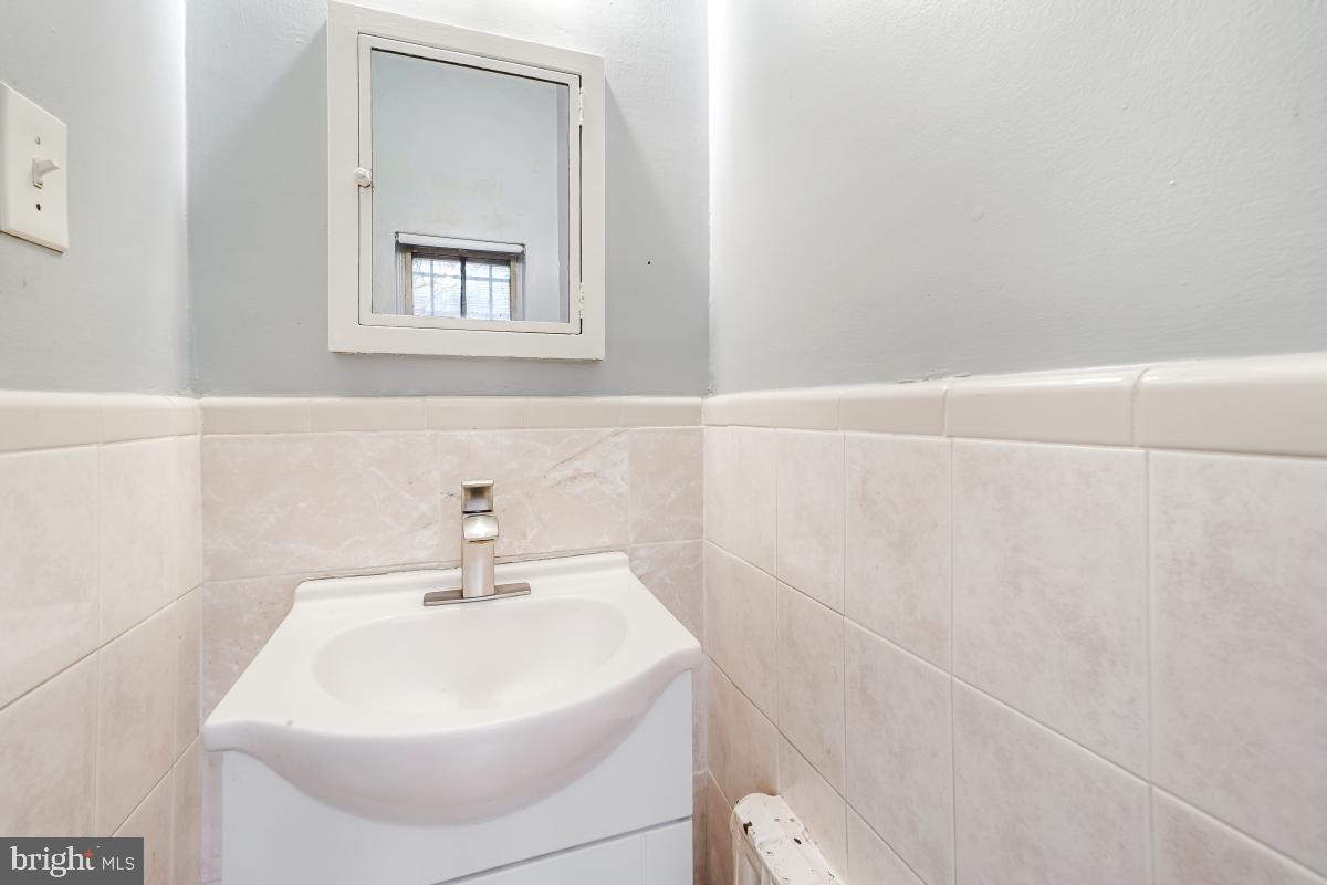 6712 6th Street Northwest Washington, DC 20012 - Photo 21 of 41 a bathroom with a sink a vanity and a window